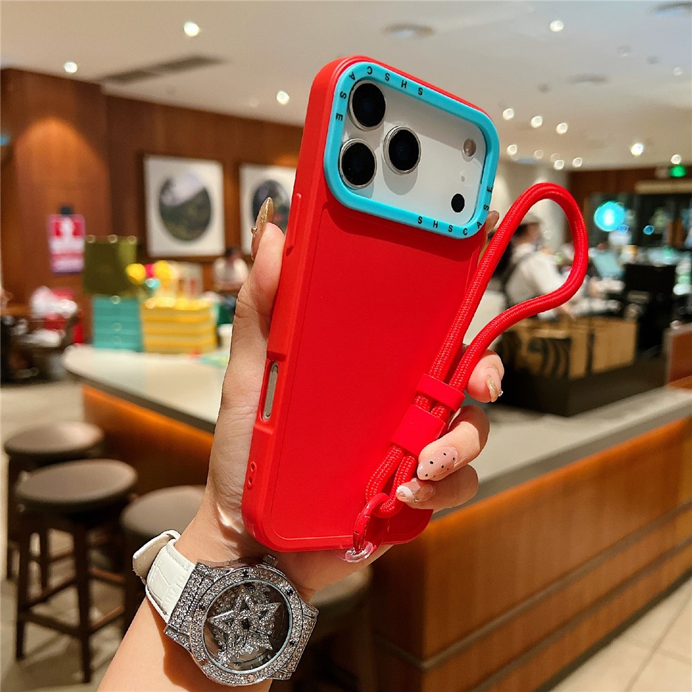 For iPhone 17 Pro Case Contrasting Colors Shockproof TPU Phone Cover with Wrist Strap - Red