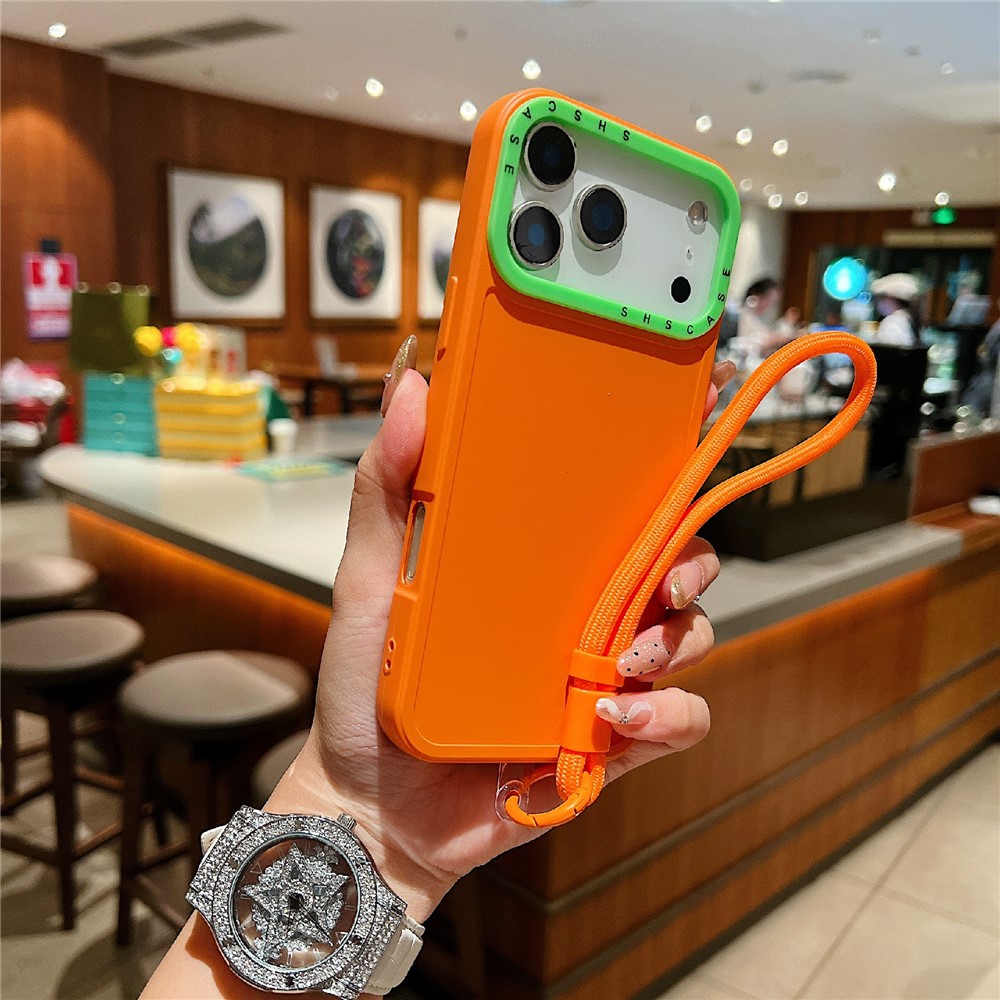 For iPhone 17 Pro Case Contrasting Colors Shockproof TPU Phone Cover with Wrist Strap - Orange